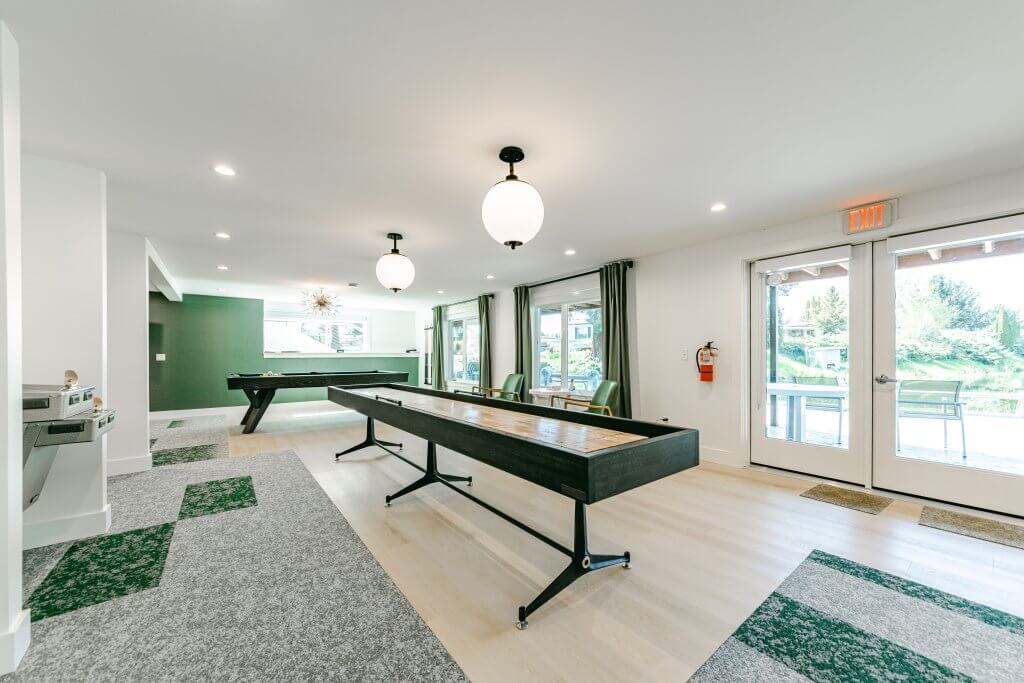 Residents game room with billiard table and shuffleboard